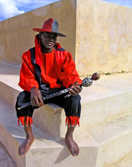 eshu the trickster with his red and black hat